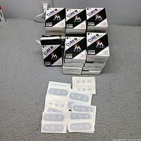 Stack of Cure It Miami Marlins bandage boxes showing front panels and quantity
