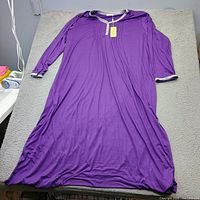 Full view of purple long-sleeve Ekouaer nightgown on table