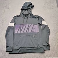 Front view of Nike hoodie showing color, logo, pocket, hood