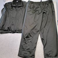 Full view of jacket and pants laid flat