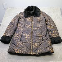Front view of leopard print puffer coat with faux fur collar and cuffs