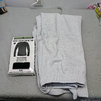 Folded light grey sweatpants beside boxed Omni Wool crew top