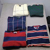 All five folded sweaters displayed