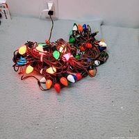 Entire pile of four light strands plugged in and lit
