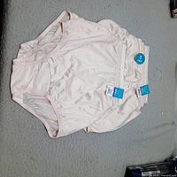 Stack of five beige Vanity Fair size 6 briefs with tags visible