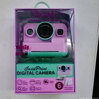 Front view of boxed XO Poppy InstaPrint digital camera