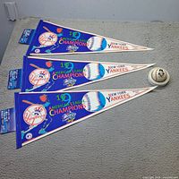 Three identical Yankees 1999 AL Champions pennants with header cards and one Paul O'Neill baseball