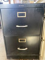 Front view showing two drawers with handles and label frames
