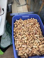 Blue Plastic tote filled with wine corks