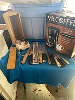 Overall lot with coffee maker box, knives, block, sharpener, whetstone