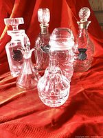 Group shot of six clear glass pieces with stoppers