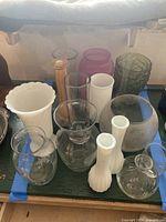 Group shot of all vases arranged within blue tape, showing variety of shapes and colors