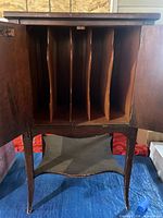 Cabinet doors open showing six interior LP slots