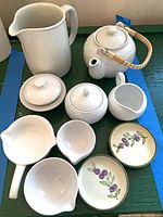 Group shot of all nine ceramic pieces on dark surface