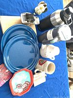 Group shot of tray, plates, drinkware, forks, board, figurine
