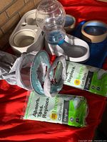Multiple pet items including water dispenser, double feeder, cat tunnel, Breeze pads