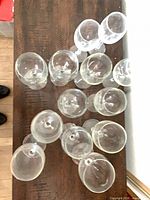 Overhead view of twelve clear wine glasses