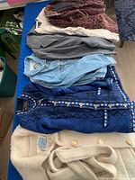 Stack of six jackets laid out showing colours and textures