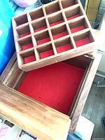 Box with tray removed showing red felt lining and wooden tray