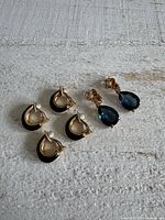 All three earring pairs; two half-hoops and one drop pair