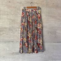 Front view of pleated floral skirt hanging