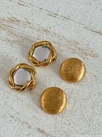 Front view showing both earring pairs on white surface