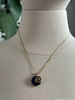 Necklace displayed on bust, full view of chain and pendant