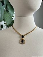 Full view of necklace on bust showing chain and pendant