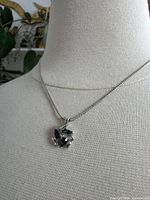 Necklace pendant close-up showing stone colors and setting