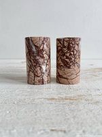 Front view of both stone candle holders showing veining