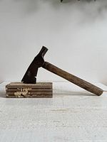 Side profile of axe inserted into wood block