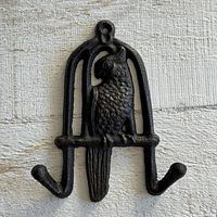 Front view of black cast metal parrot wall hook showing design and hooks