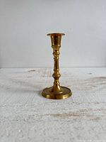 Full view of brass candlestick holder standing upright