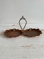 Front view of copper double dish with handle