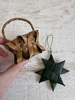Miniature woven basket and green star ornament side by side