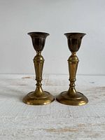 Front view of both brass candlestick holders