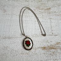 Full view of necklace laid flat showing chain and pendant