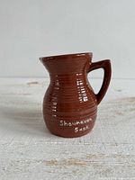 Front view showing shape, glaze and Shaunavon Sask lettering