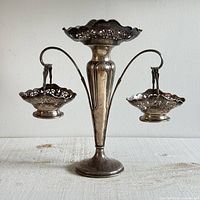 Front view of assembled sterling epergne with baskets attached