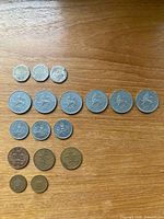 All seventeen coins laid out by denomination