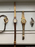All four vintage ladies watches laid out side by side