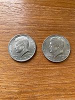 Both Kennedy half dollars obverse visible