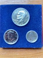 Close-up of three proof coins in blue felt holder