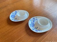 Pair of blue floral Figgjo Norway oval egg cups on wooden surface