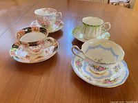 All four Royal Albert teacup and saucer sets displayed