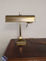 Front view of banker’s lamp on wooden surface