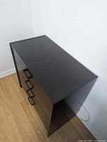 Front left perspective of black 4-drawer dresser