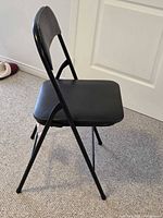 Side view of black folding chair