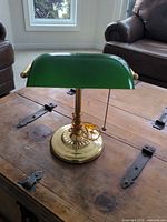 Front view of brass-plated banker's lamp on table