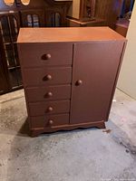 Front view of dresser showing 5 drawers, side cabinet door closed